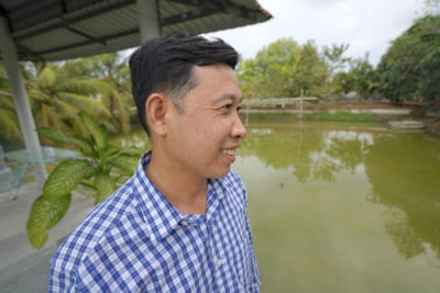 Tieu Hoang Pho at his freshwater pond in Phú Tân, where he collects rainwater and raises fish.
