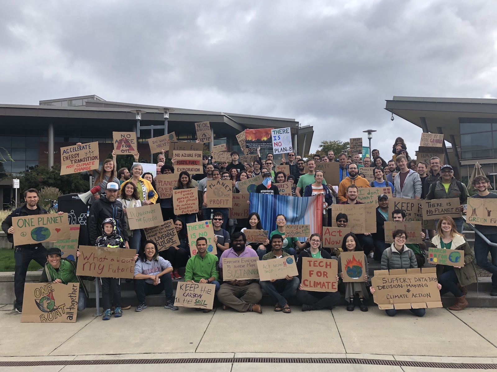 a group of people holding cardboard protest signs