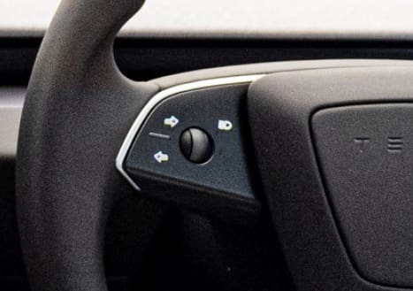 Tesla Model 3 indicator buttons on steering wheel.