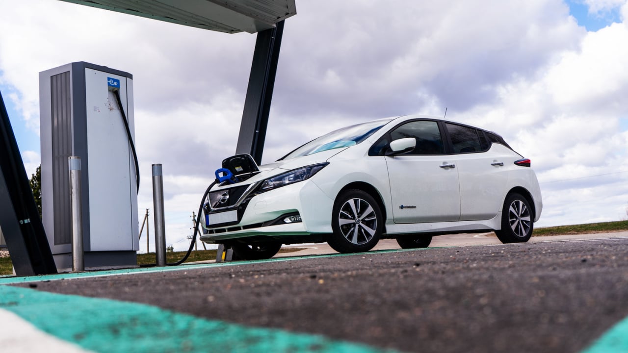 Electric car charging point with Nissan Leaf connected. EV parking and recharging station. 