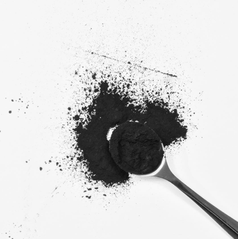 activated charcoal and metal spoon