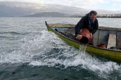A fisher releases young Ohrid trout back into the Albanian portion of Lake Ohrid last November.