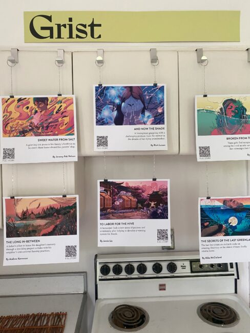 postcards with images and text at a art opening above a gas stove
