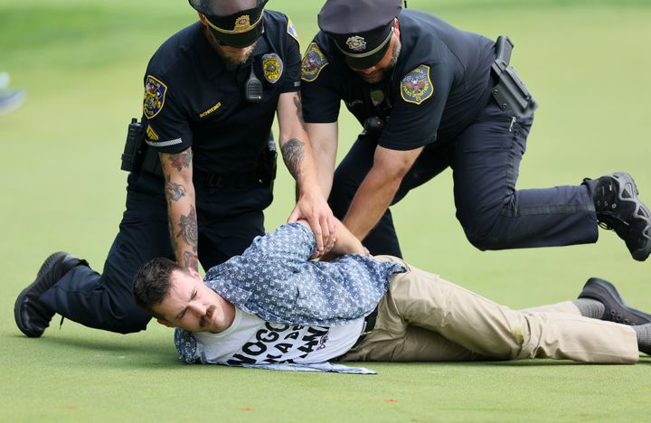 Six Climate Protesters Run Onto 18th Green And Spray Powder, Delaying Finish Of PGA Tour Event