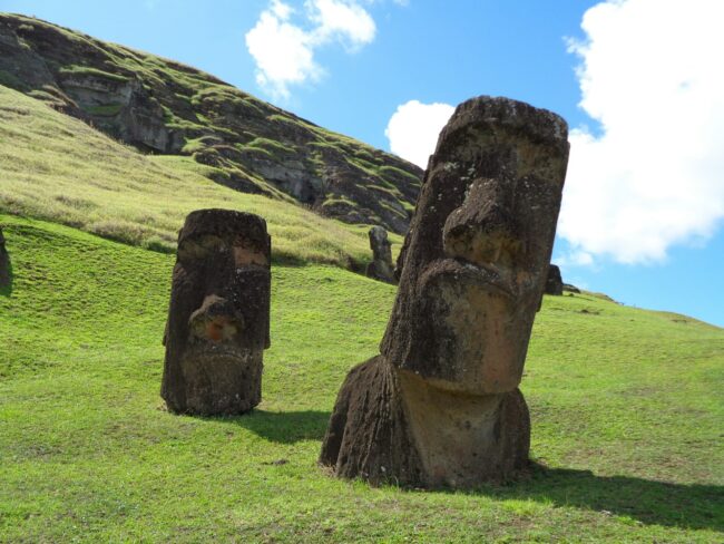 Large ancient statues on an island.