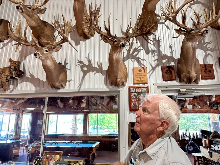 Robert Williams admires mounts made of sheds from captive deer he bred at RW Trophy ranch on July 27, 2023.